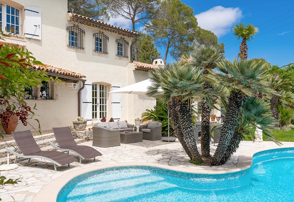 lounge chairs next to pool in south of france house