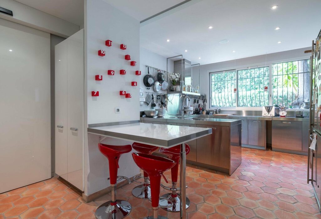 kitchen with modern design and red accent chairs