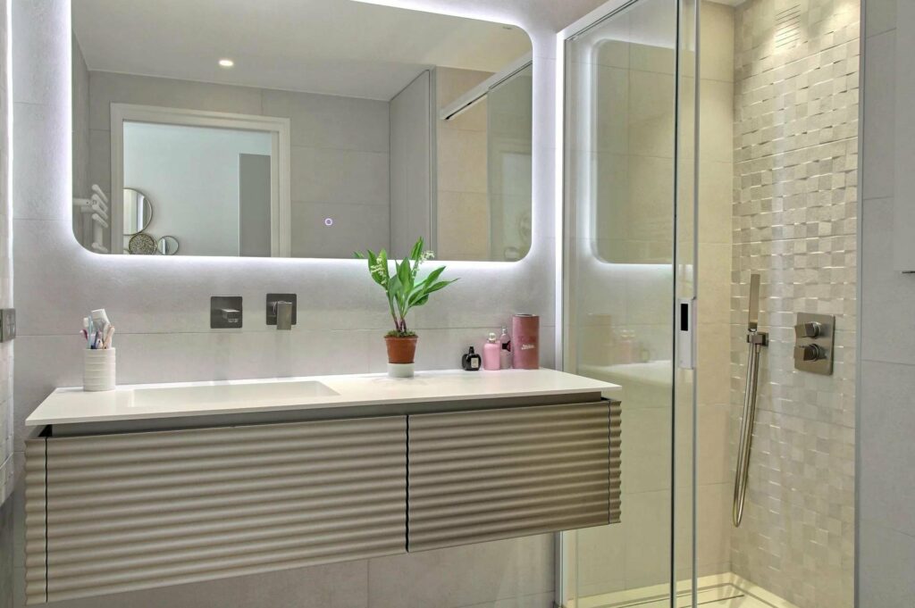 white modern bathroom with large mirror in central cannes apartment