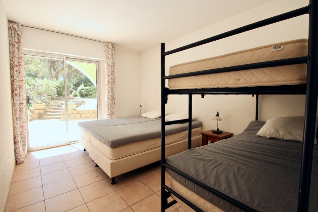 bedroom of apartment in saint tropez with bunk bed and queen size bed