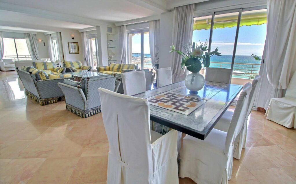 dining room with glass table at luxury apartment in cannes