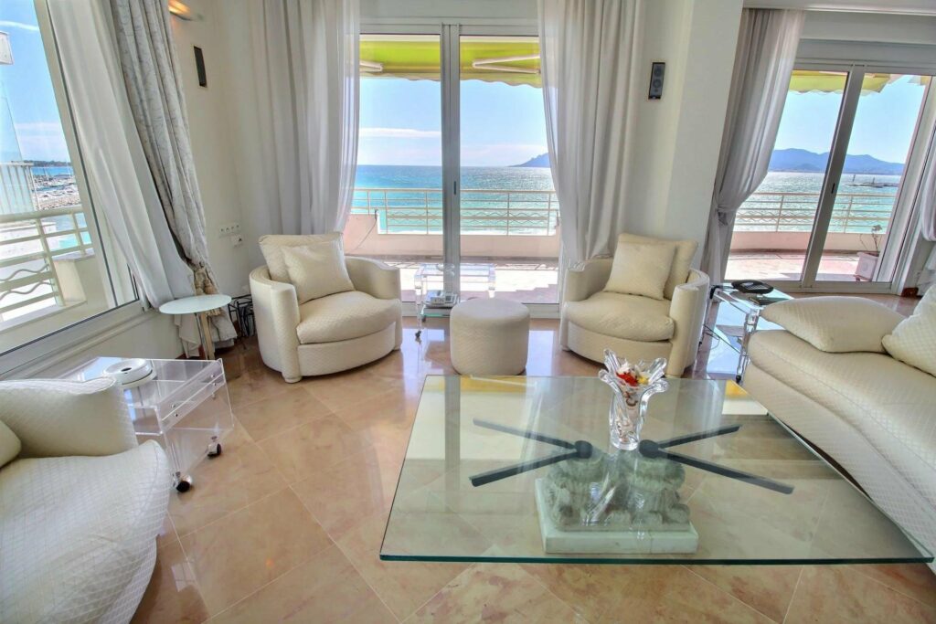 living room area of apartment cannes croisette with white chairs