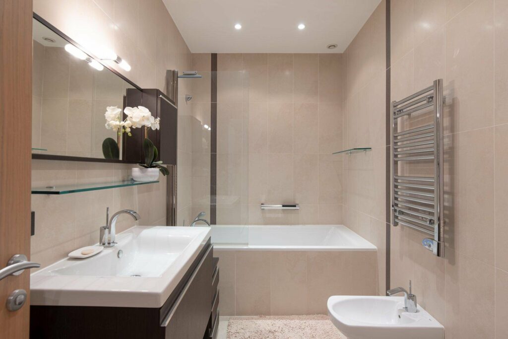 large open bathroom of apartment in cannes with beige tiling
