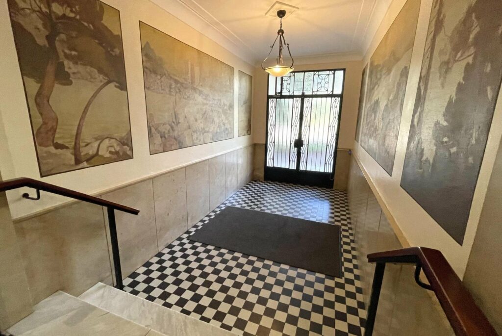 entrance of building in cannes with black and white checkered floors