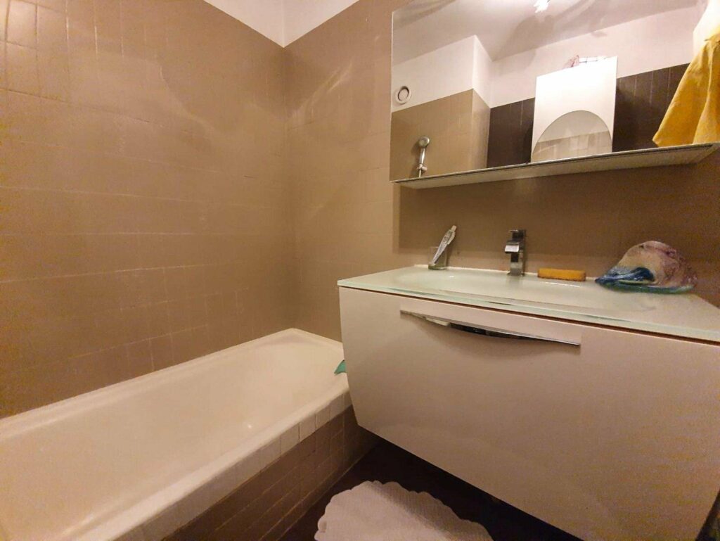 bathroom with white bathtub and sink area