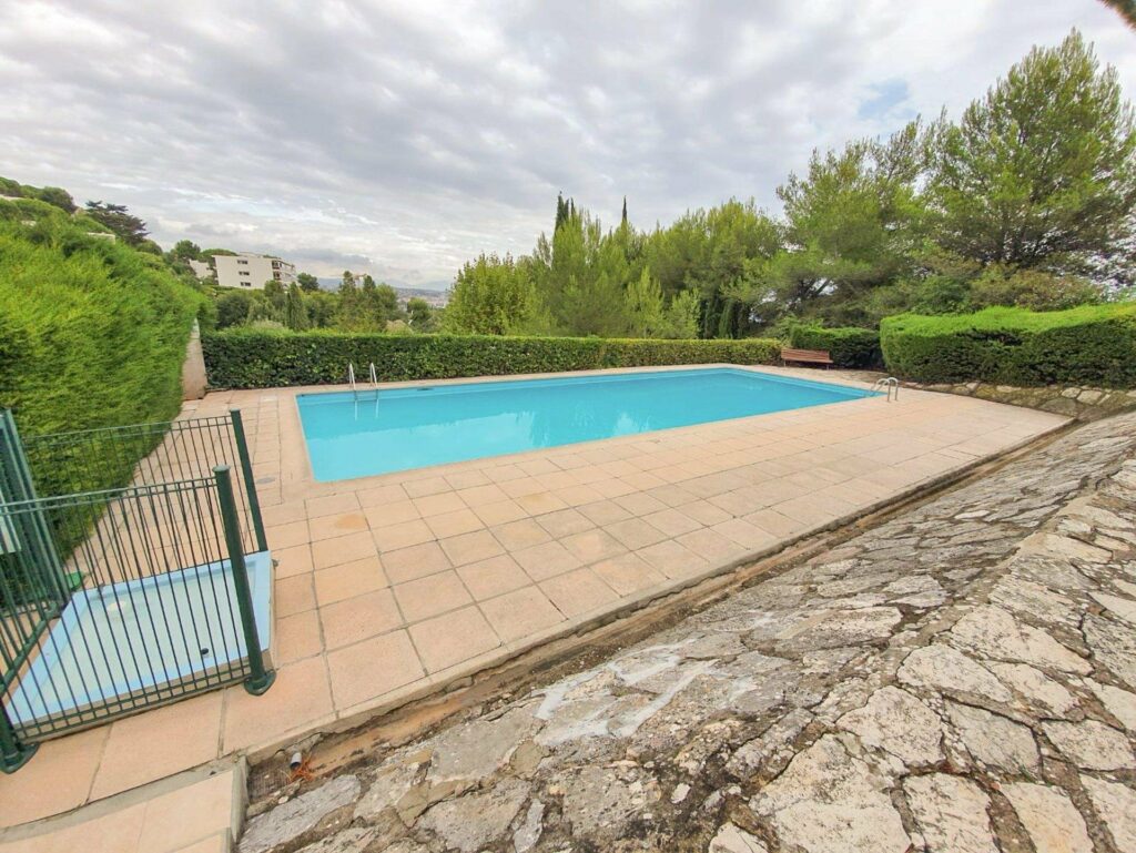backyard with swimming pool of apartment for sale in south france