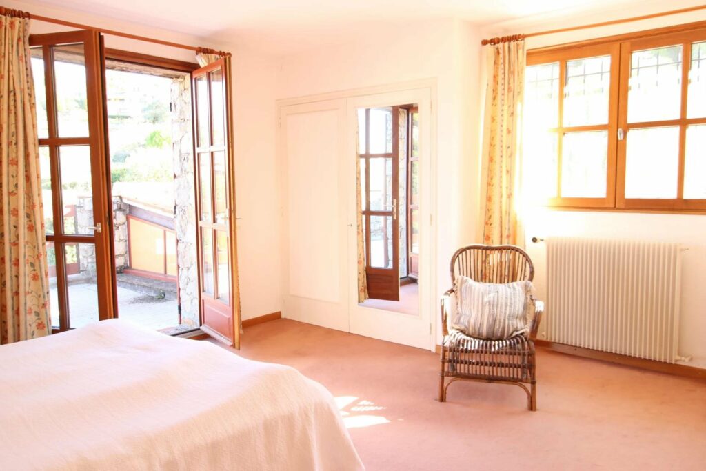 bedroom of provencal house for sale with open french doors to terrace
