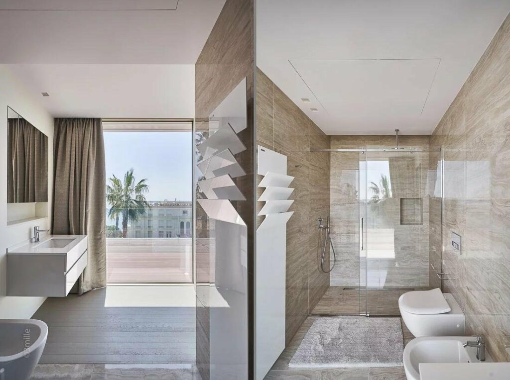 bathroom with view of bedroom on side with standing glass shower