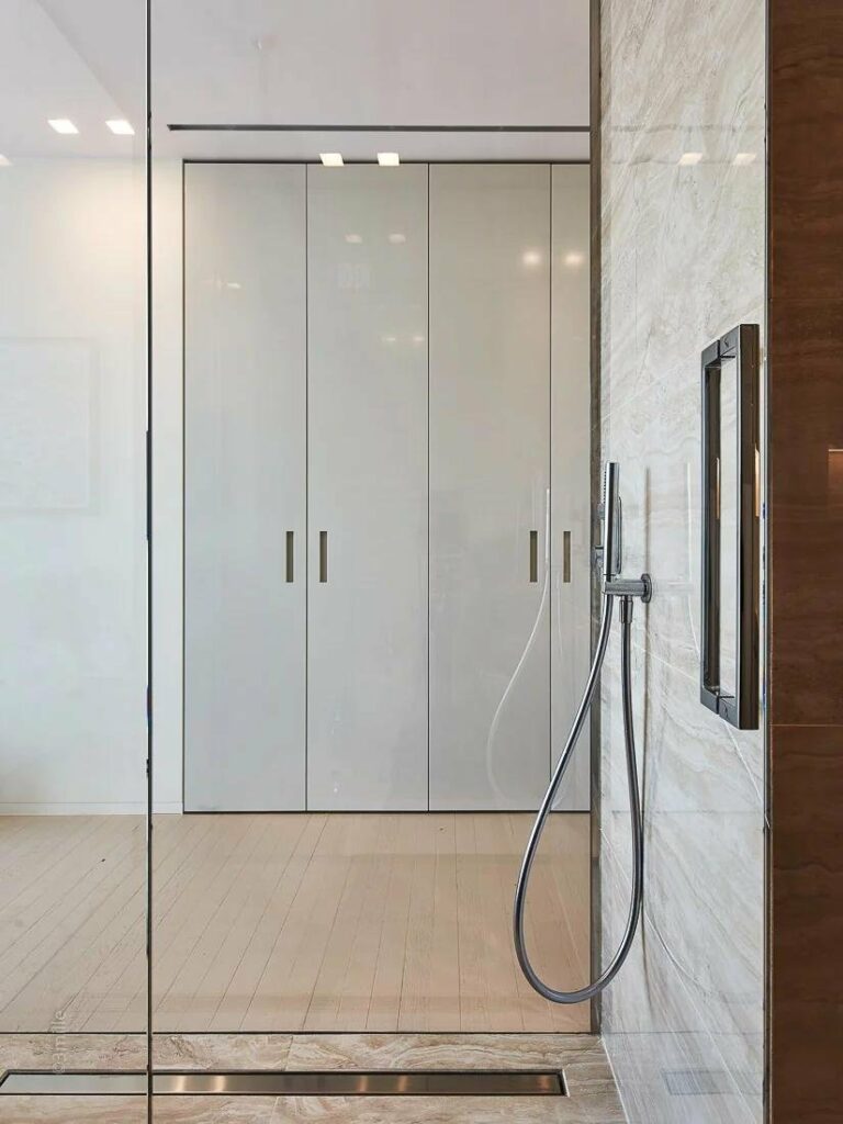 modern glass standing shower with white tiling