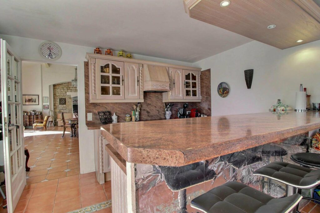 kitchen with brown granite bar and light brown cabinets