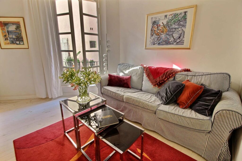 living room next to large french doors and red rug with modern center table