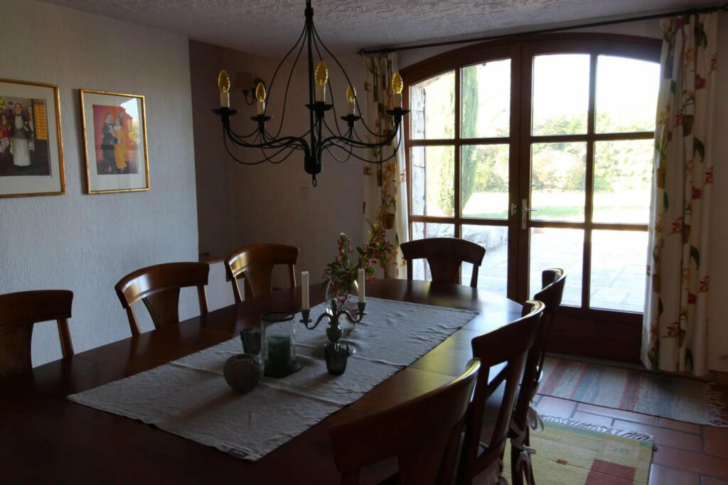 dining room with large wood table facing garden view