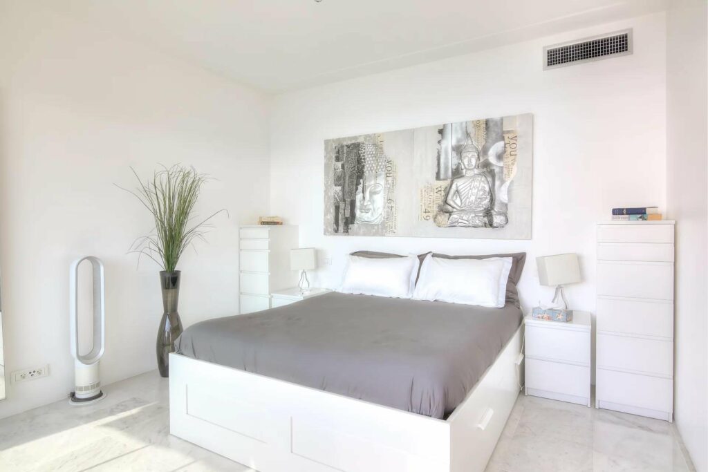 bedroom with grey bedding at apartment in menton for sale