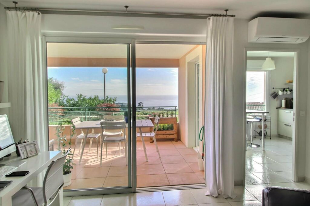 sliding glass door to terrace with view of mountains in nice