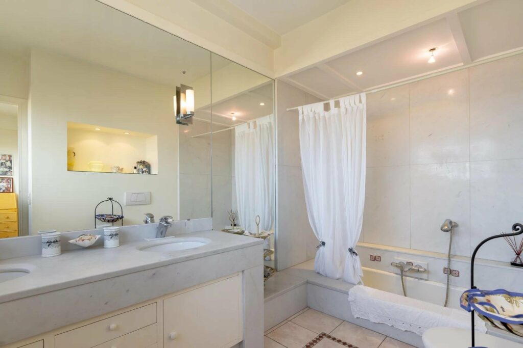 bathroom with beige tile standing shower