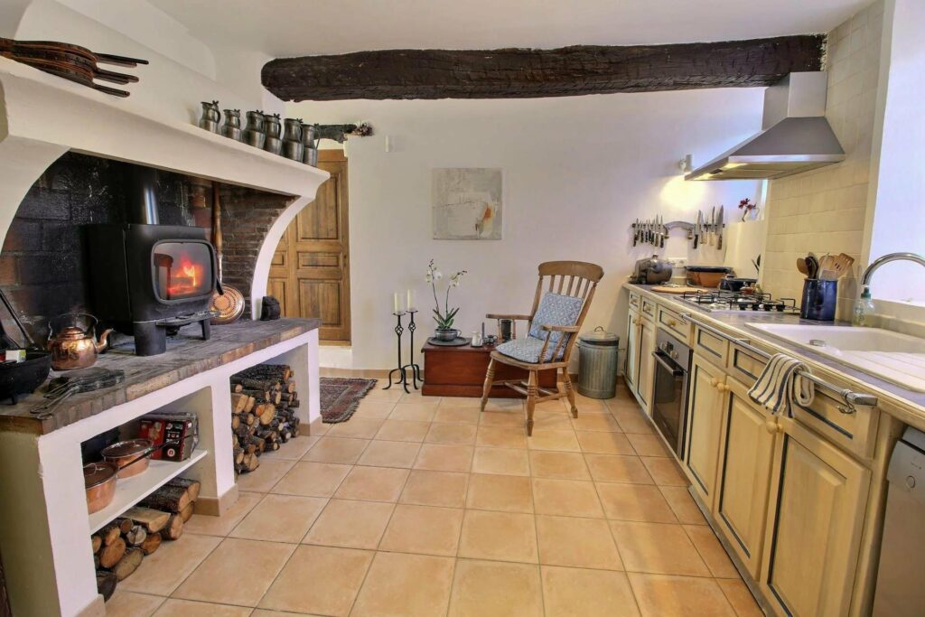 kitchen area of village house in seillans with beige tile floors