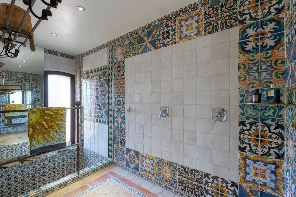 bathroom with colorful tile walls and bathtub