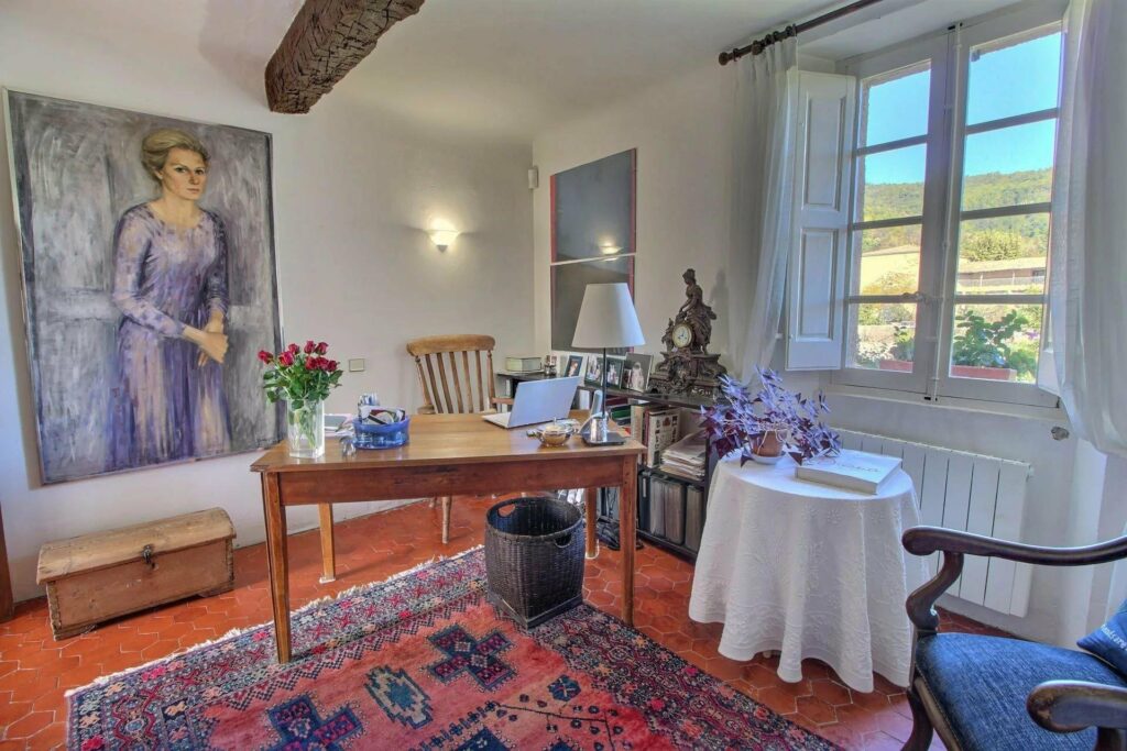 room in seillans village house with printed design rug and window with garden view