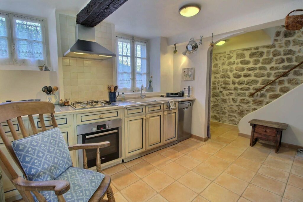 kitchen with beige tile floors and cream counter
