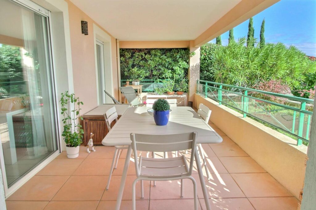 terrace with tile floors and white table with view of garden