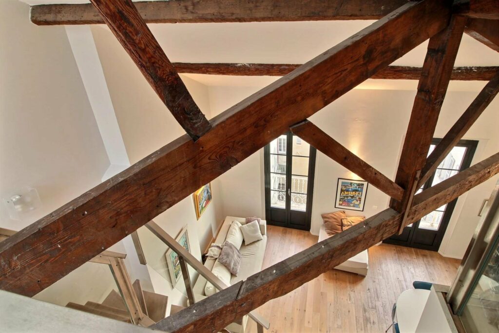 apartment with mezzanine and exposed wooden beams