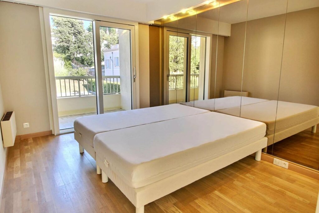 large balcony with large bed and mirrored wall