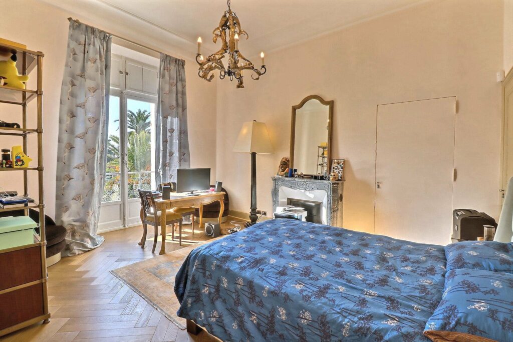 bedroom with navy blue floral bedding and vanity in corner
