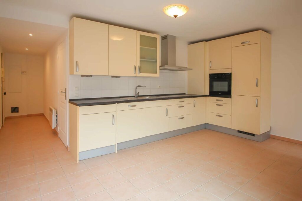 open kitchen of apartment in menton with beige tile floors
