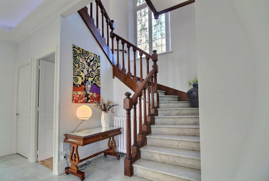 wooden stairway leading upstairs in townhouse in cannes