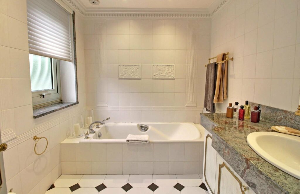 bathroom with white bath tub and black and white checkered floors
