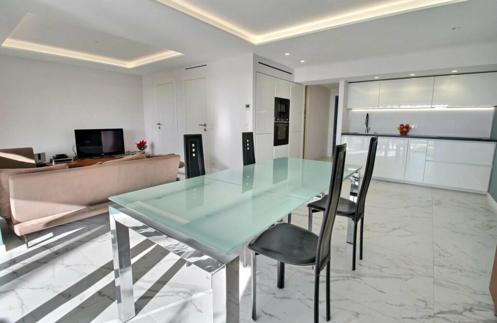 dining room with glass top table and marble floors