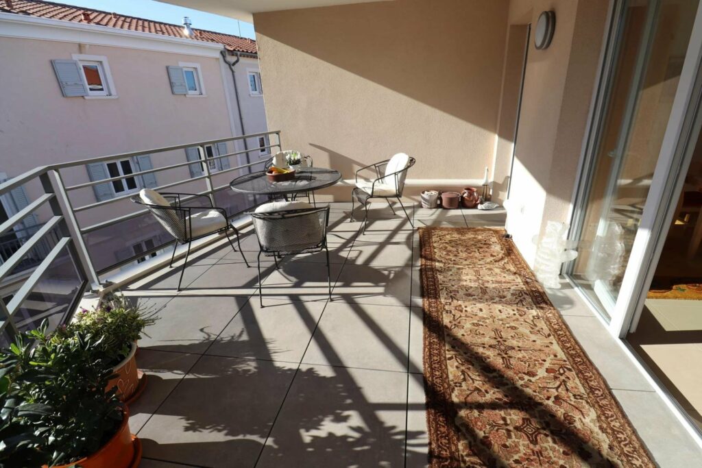 terrace with outdoor furniture and grey long rug