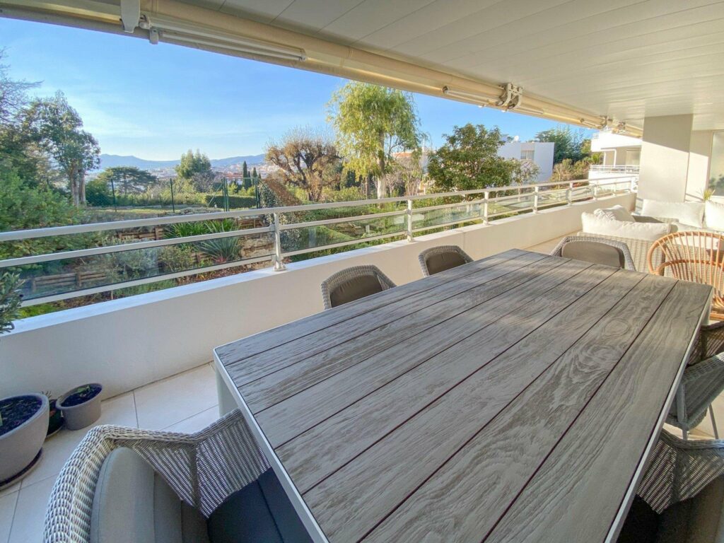 large terrace with grey table of apartment for sale in cannes