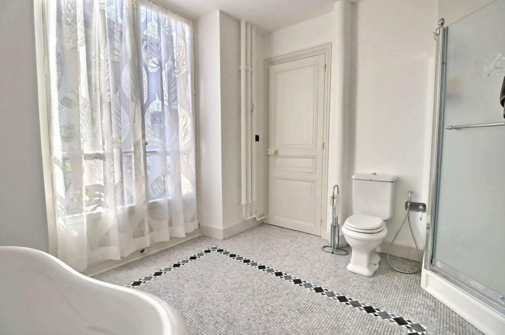 large open white bathroom of apartment in cannes