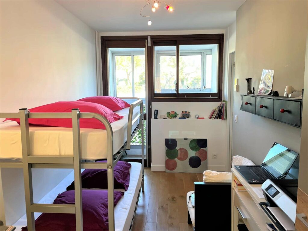 kids bedroom with bunk beds with access to small terrace