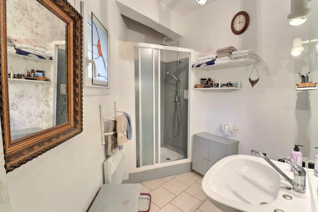 bathroom with standing shower and beige tile floors