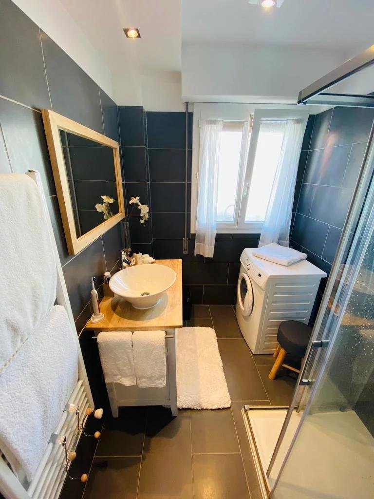 bathroom with chic design and navy blue walls white light brown cabinets