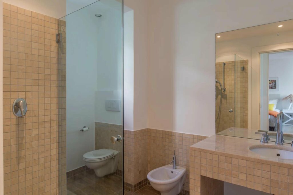 bathroom with large standing shower with glass door