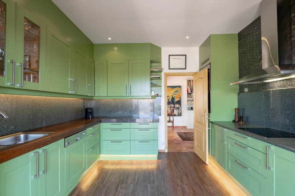 kitchen with green cabinets and wooden floors