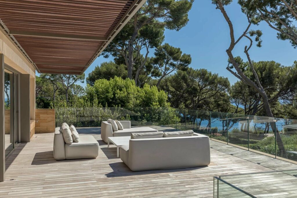 outdoor seating area with white outdoor sofas facing sea view