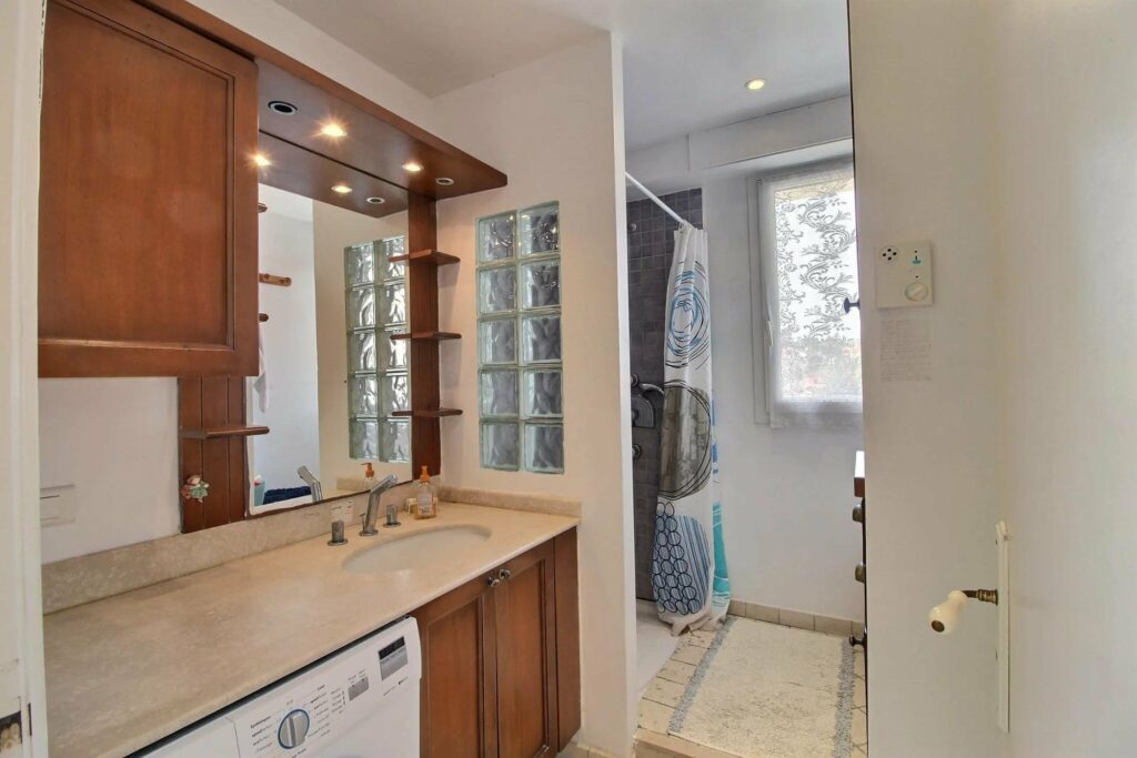 bathroom with wooden cabinets and beige tile
