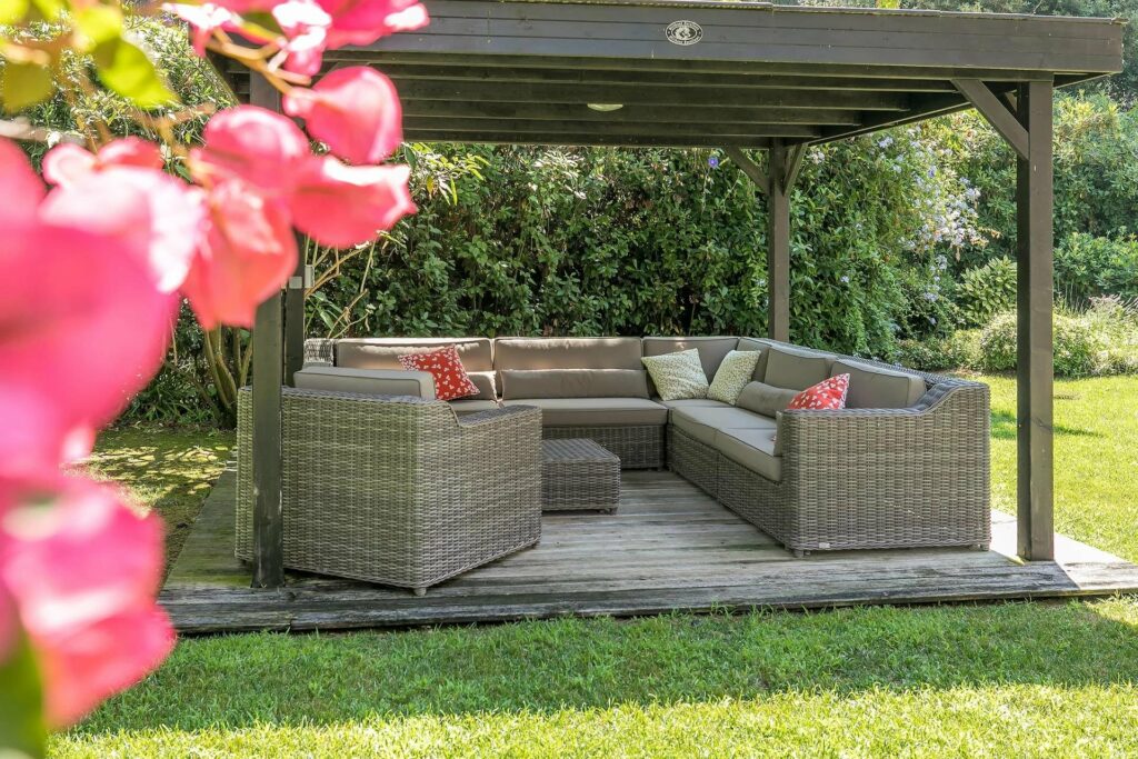 shaded backyard seating area with brown sofas