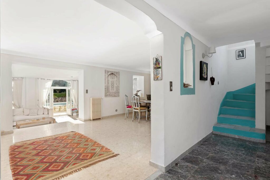 interior of villa with beige tile floors and high white ceilings