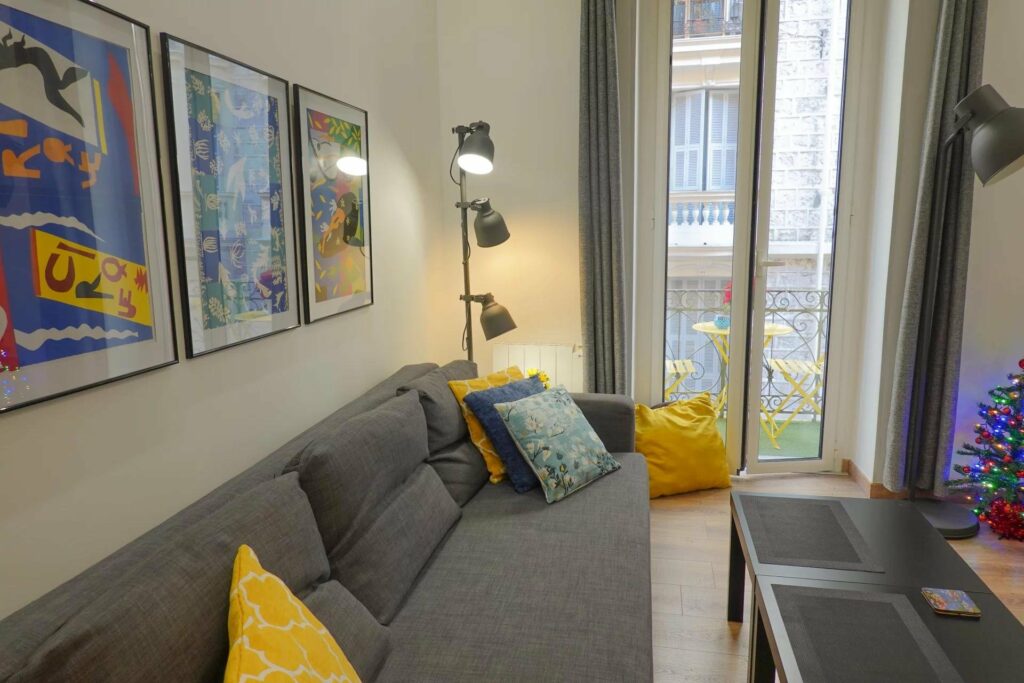 living room with grey couch and yellow accent pillows
