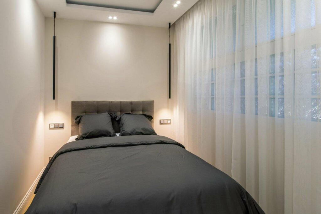 bedroom with dark grey bedding on a double size bed