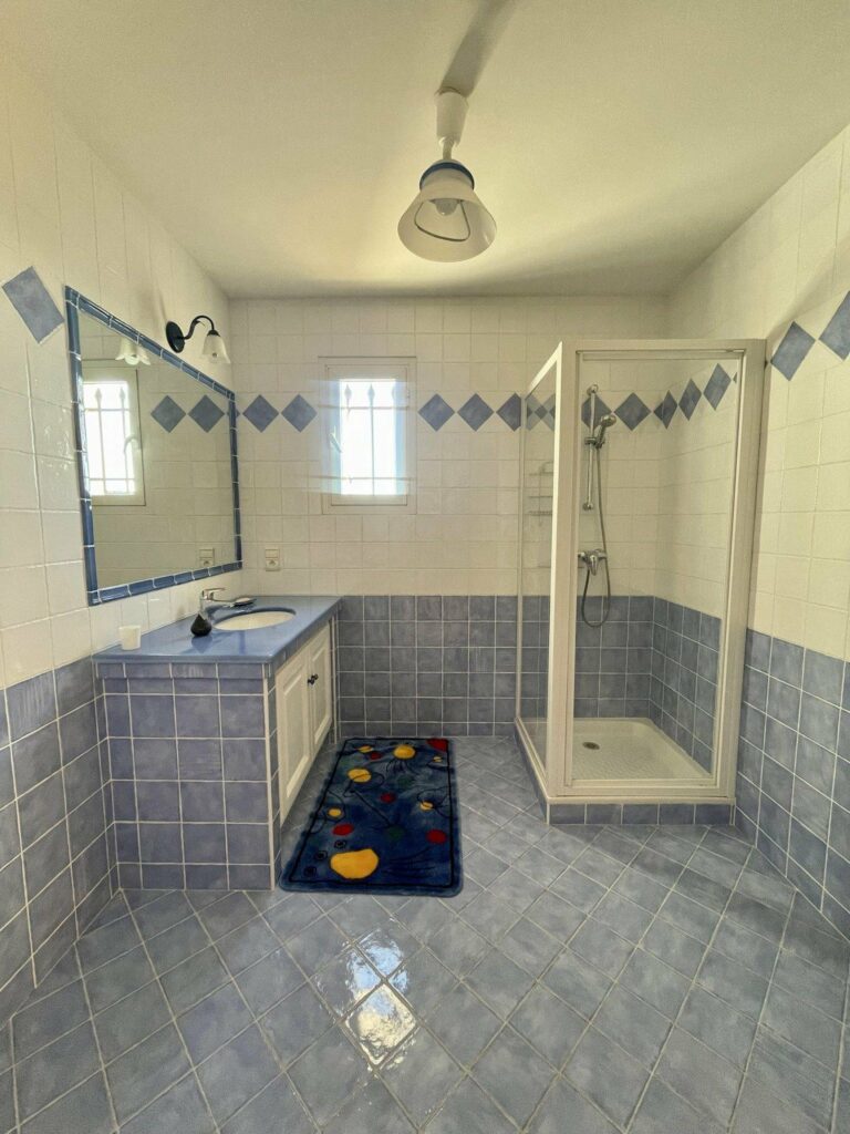 bathroom with blue tile walls and floors