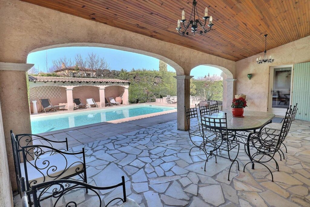 backyard with stone tile and view of swimming