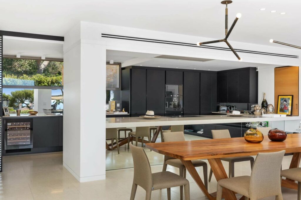 modern kitchen with black cabinets and long kitchen island