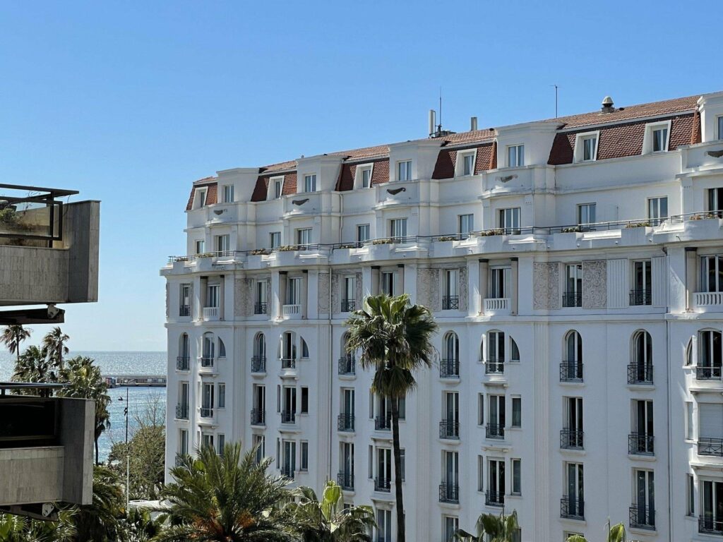 all white apartment building in cannes with classical french architecture