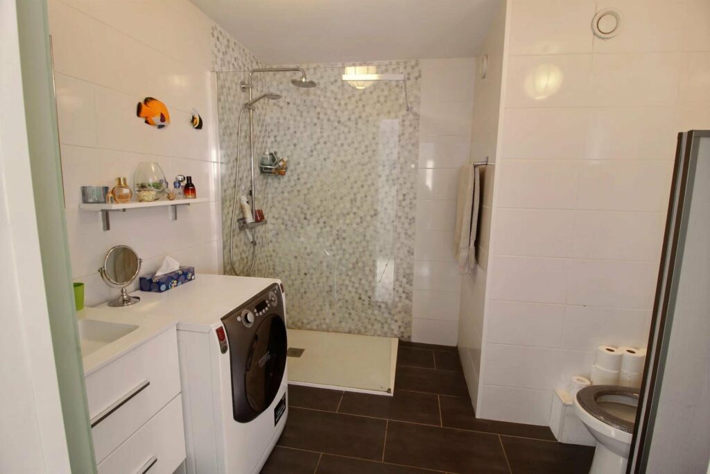 bathroom with white tiling and large standing shower